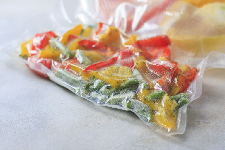 Vegetables in sealed vacuum packing bags. Su-video cooking. Selective focus